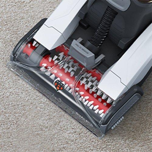 Close-up of the brush roll assembly of a Hoover carpet cleaner, emphasizing the design and effectiveness of the brushes in agitating and removing dirt from carpets.