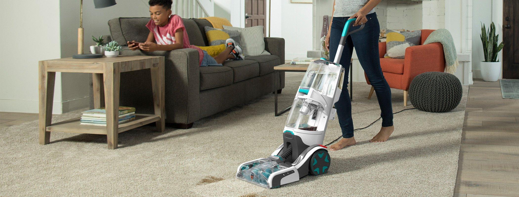 Using a Hoover Smartwash+ automatic carpet cleaner in a living room, illustrating ease of use