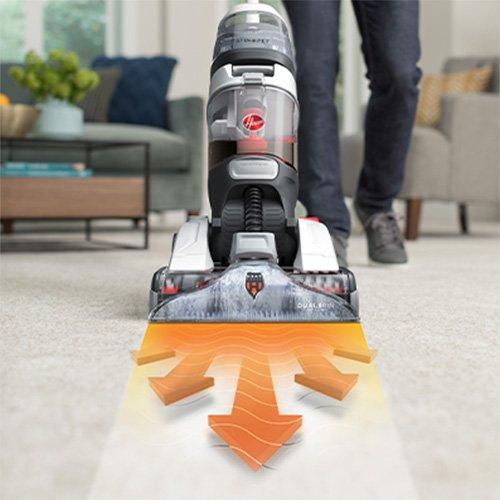 Hoover carpet cleaner in action on a carpet, with visual indicators illustrating its deep cleaning technology and effectiveness in dirt removal.