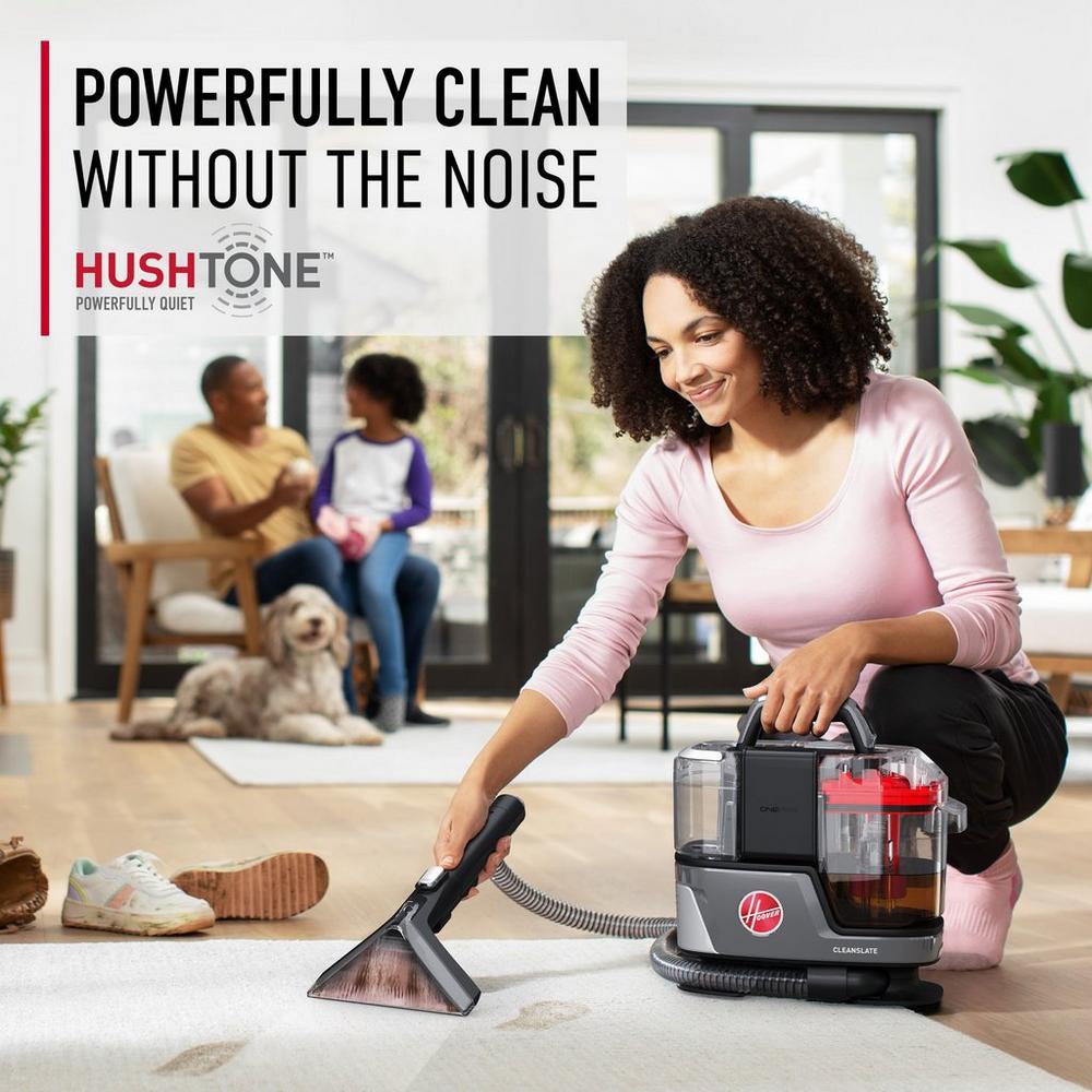 Woman using her ONEWPR spot cleaner to remove mud footprints from her light colored carpet, while around her family and dog highlighting its powerful clean without the noise.