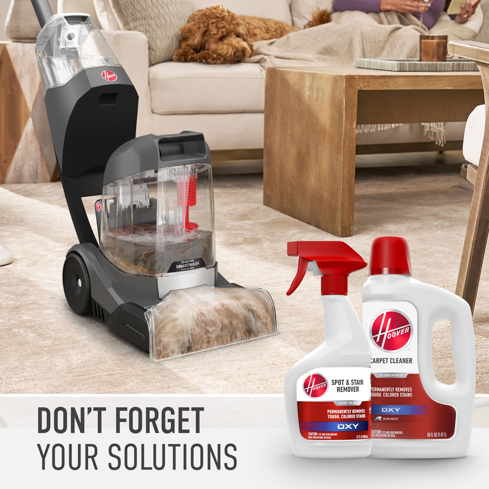 Hoover carpet cleaner with accompanying spot and stain remover solutions for deep cleaning, shown in a living room setting.