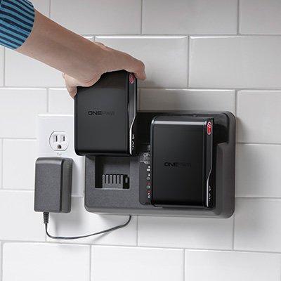 Person inserting their Hoover battery into the Hoover dual bay charger, which allows for longer cordless cleaning.