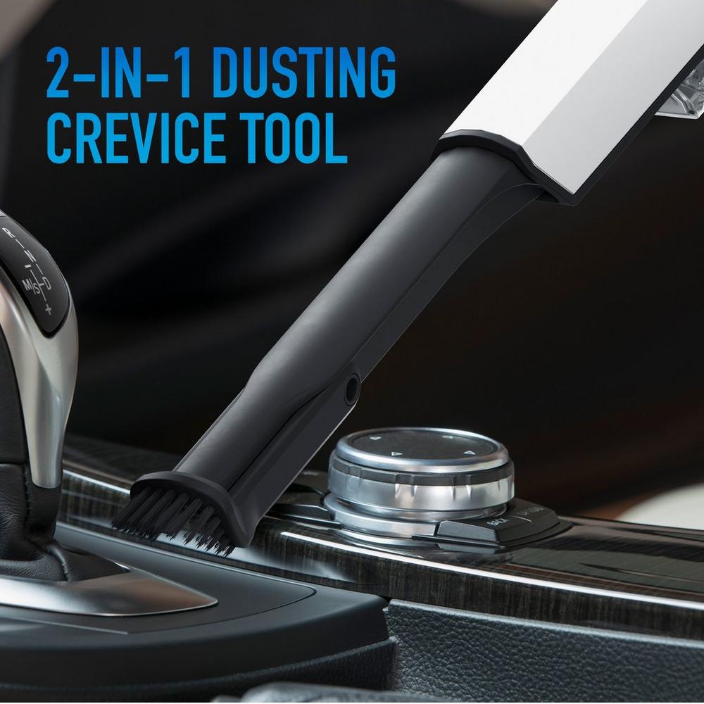 Close-up. of a 2-in-1 dusting crevice tool cleaning a car's interior, highlighting its versatility for dusting and reaching tight spaces.