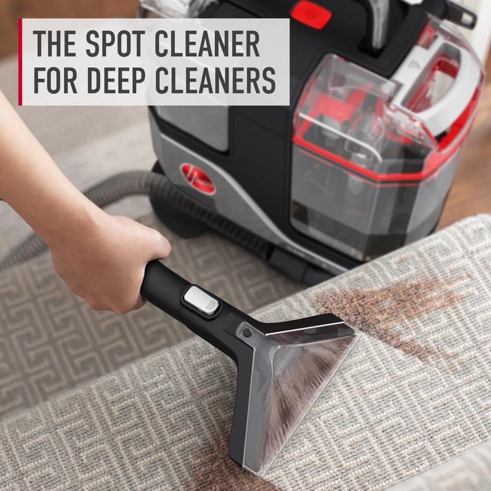 A Hoover spot cleaner being used to remove a brown stain from a patterned carpet, highlighting its deep cleaning capabilities. The text 'the spot cleaner for deep cleaners' is displayed, emphasizing the product's effectiveness for thorough cleaning