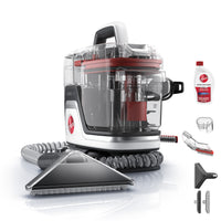 Front facing Hoover portable spot cleaner with included accessories: trial sized solution, hose rinse tool, tight spot tool, and 7" wide path tool.