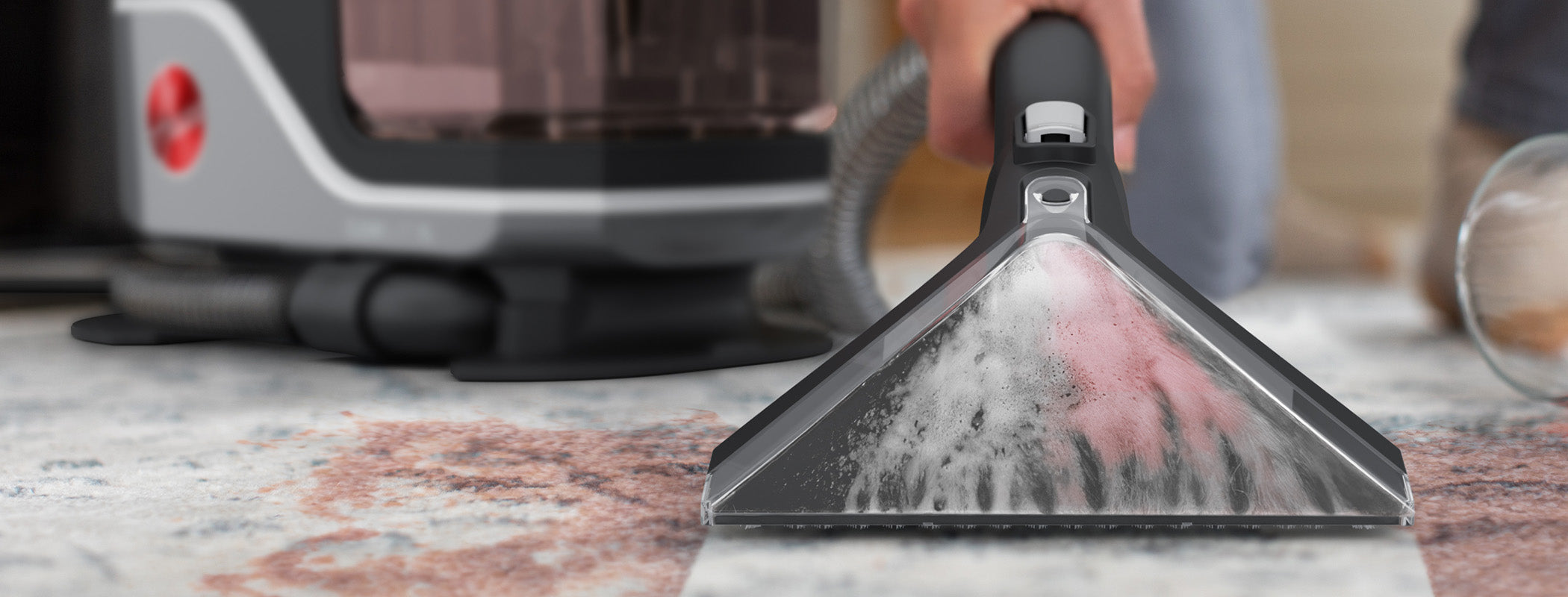 Close up of the most powerful Hoover spot cleaner in action, deep cleaning a tough stain on a white carpet