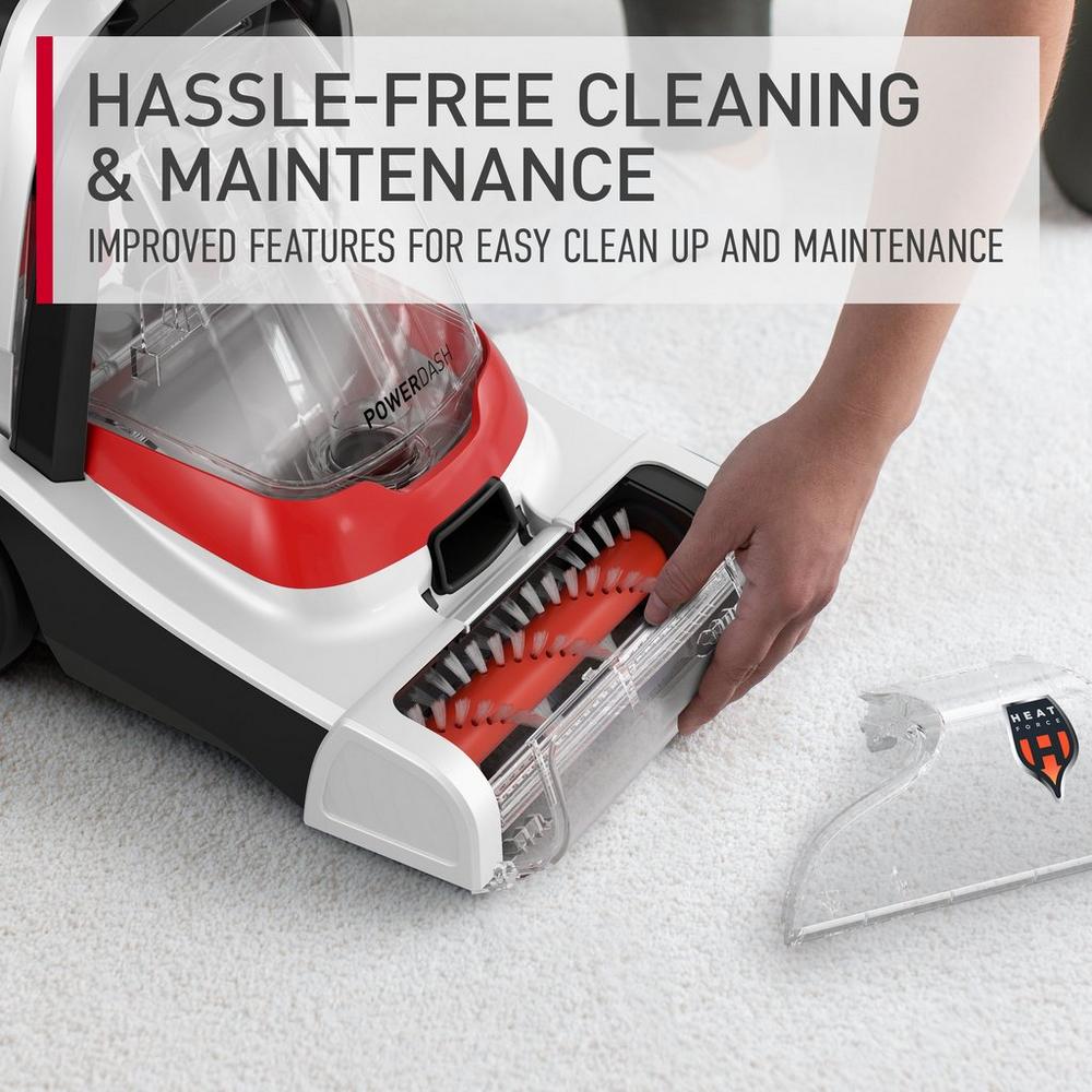 Person demonstrating hassle-free cleaning and maintenance by removing the brush roll from a Hoover carpet cleaner, showcasing improved features for easy upkeep.