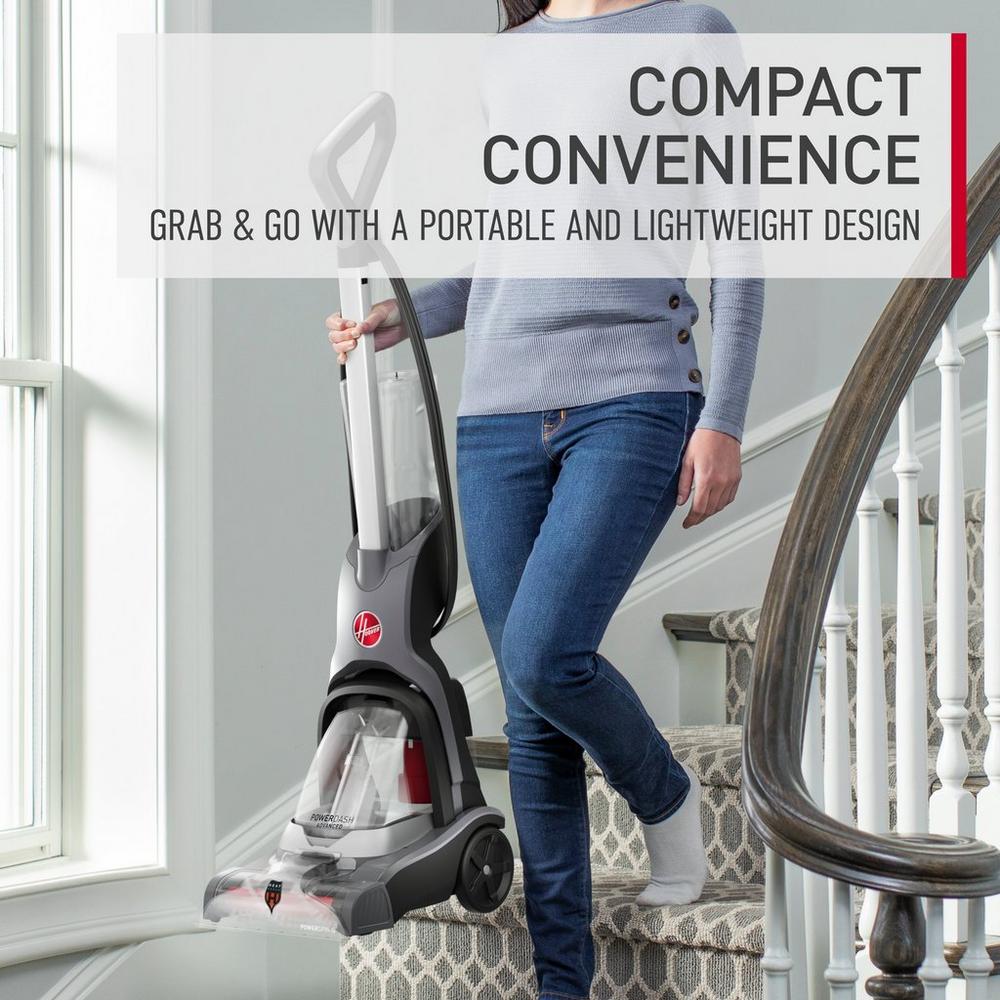 Woman easily carrying her powerdash pet advanced down the stairs showcasing its compact convenience. She is able to grab and go since her powerdash pet advanced has a portable and lightweight design.