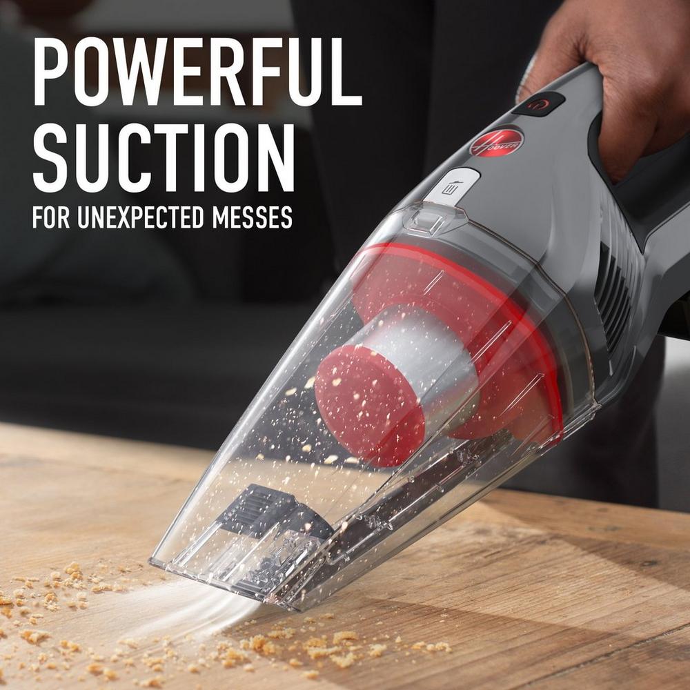 Hoover handheld vacuum cleaner is shown in action vacuuming crumbs, showcasing its powerful suction.