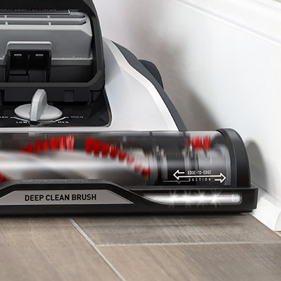 Close up of Hoover vacuum cleaner effectively cleaning the baseboards edge.