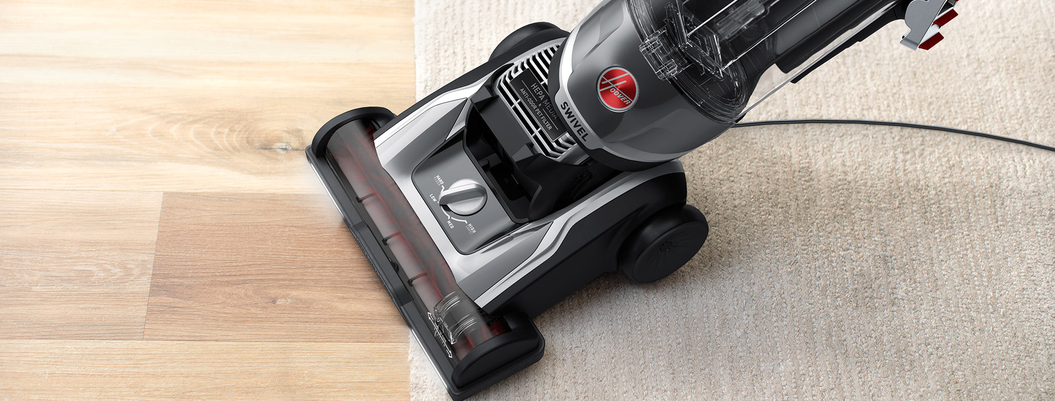 Close up of High performance swivel xl in action transitioning from carpet to hard floor highlighting its ability to effectively vacuum multi-surfaces.