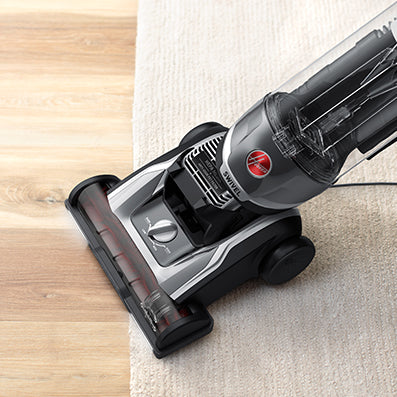 Close up of High performance swivel xl in action transitioning from carpet to hard floor highlighting its ability to effectively vacuum multi-surfaces.