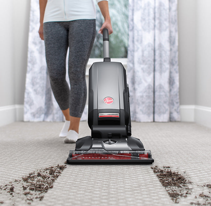 Hoover vacuum cleaner effectively lifting and removing embedded dirt from a carpet.