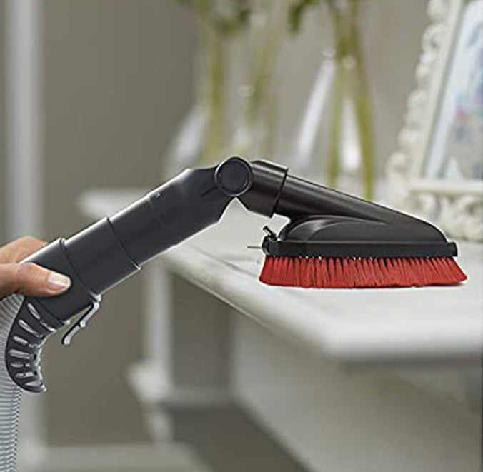 Close of up Windtunnel's pivoting dusting brush being used to dust a shelf, showcasing its flexibility perfect for cleaning hard to reach spots like bookshelves, ceiling fans, vents and more
