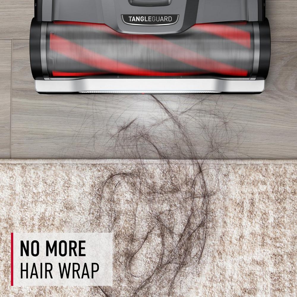 Close up of Hoover vacuum cleaner with tangleguard technology removing hair from carpet, featuring text "no more hair wrap"