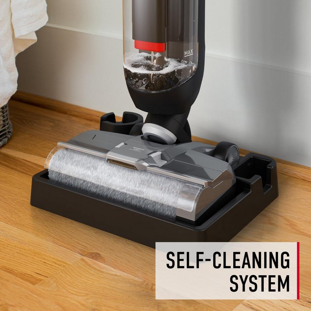 Close-up of a vacuum cleaner's brush roll automatically cleaning itself in the Hoover docking station. 