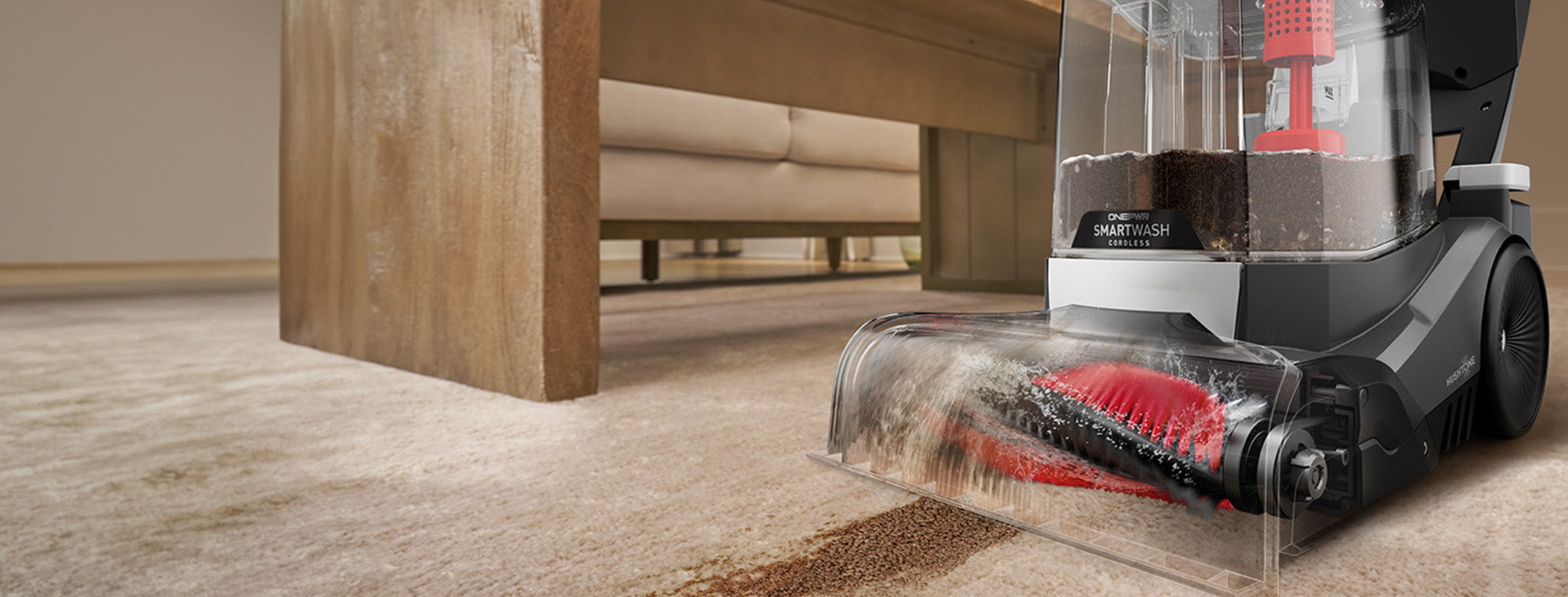 Cordless carpet cleaner washing a carpet that has dirt on it