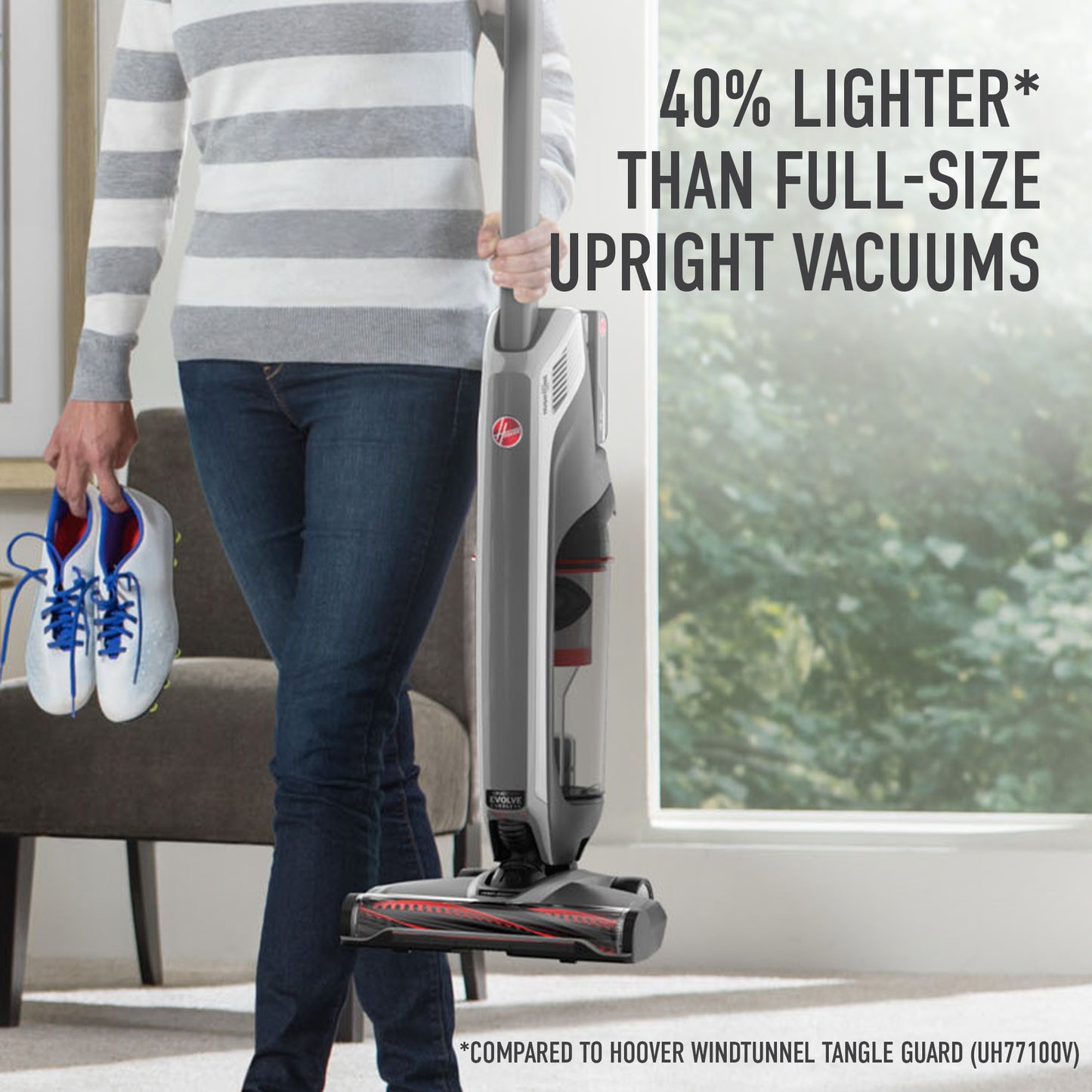 Woman effortlessly carrying her ONEPWR evolve pet elite in one hand and shoes in another emphasizing that it is 40% lighter than full size upright vacuums