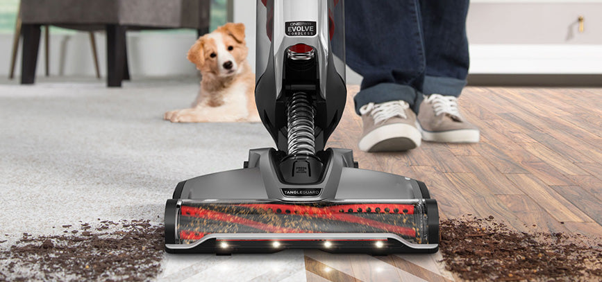 Vacuum cleaner vacuuming dirt on a hard floor surface and carpet