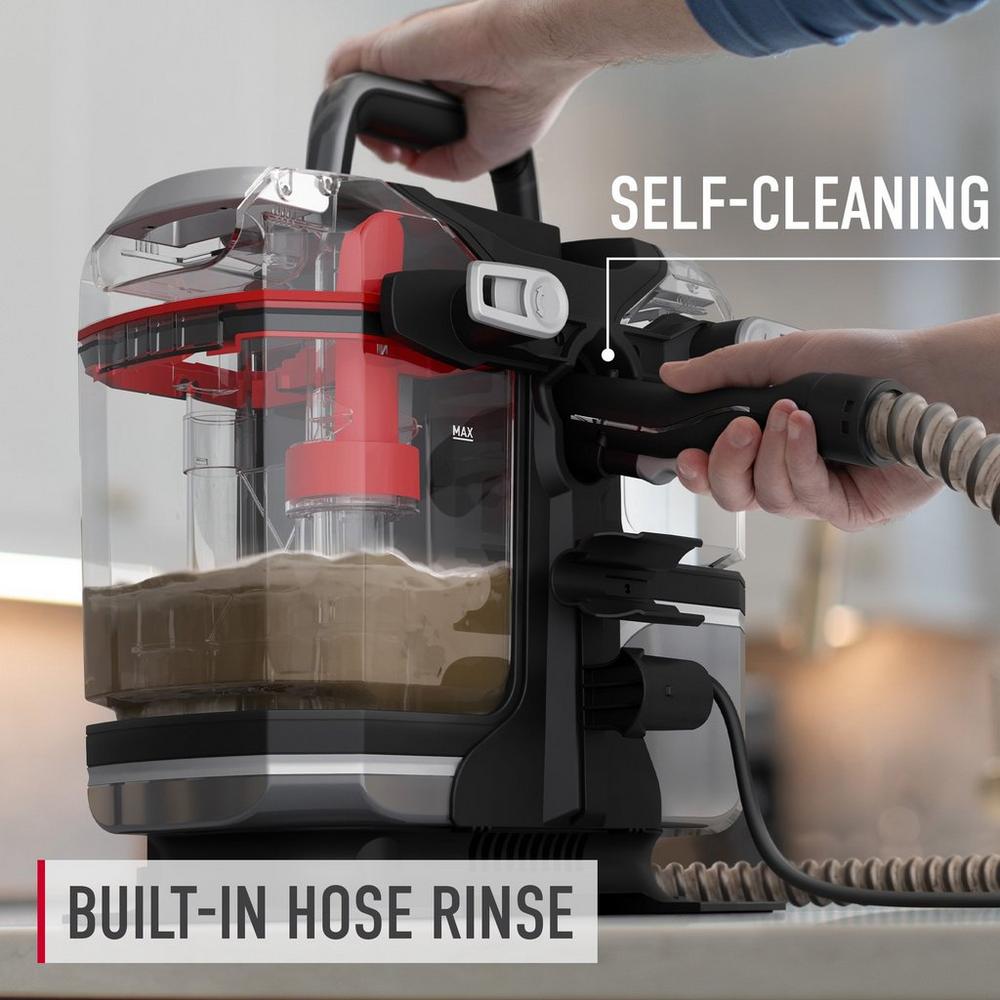 Close up of Hoover spot cleaner with built in hose rinse feature and self cleaning function highlighting the ease of maintenance