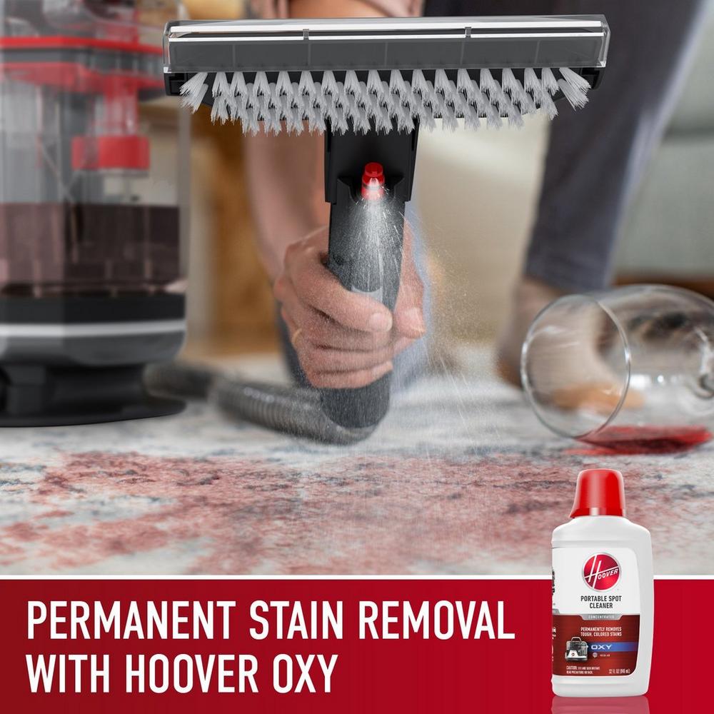 Close up of Hoover widepath tool spraying the permanent stain removal oxy formula on a red wine spill to effectively remove the stain from a carpet