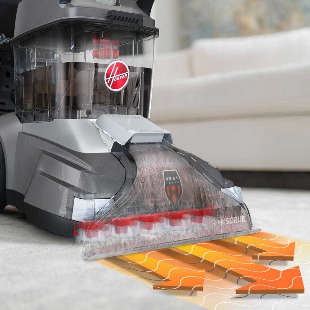 Hoover carpet cleaner with HeatForce technology actively cleaning a carpet, showcasing its SpinScrub brushes for effective stain removal and deep cleaning.