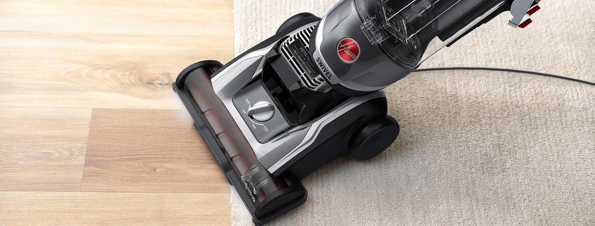 Close up of High performance swivel xl in action transitioning from carpet to hard floor highlighting its ability to effectively vacuum multi-surfaces.