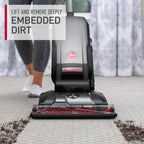 Hoover vacuum cleaner in use effectively lifting and removing deeply embedded dirt from a carpet.