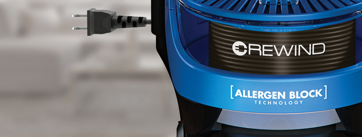 Close up of Hoover Elite vacuum cleaner's rewind feature, showing the power cord plug and emphasizing cord storage and ease of use.  