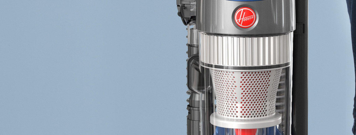 Close up of the Hoover whole house rewind upright vacuum cleaner, focusing on the top section of the vacuum showcasing its sleek design and advanced filtration system. 
